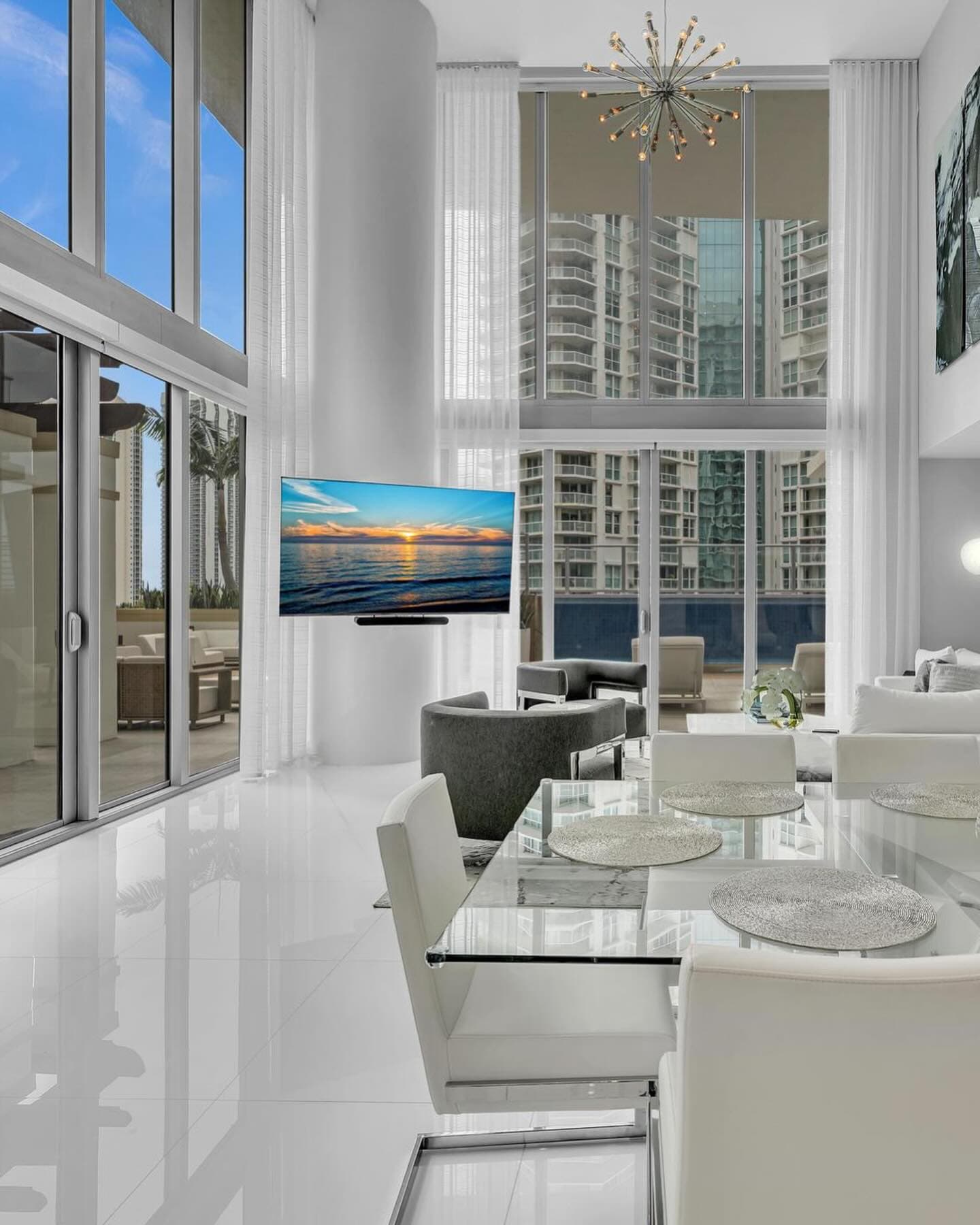 Double-height living and dining room with floor-to-ceiling windows
