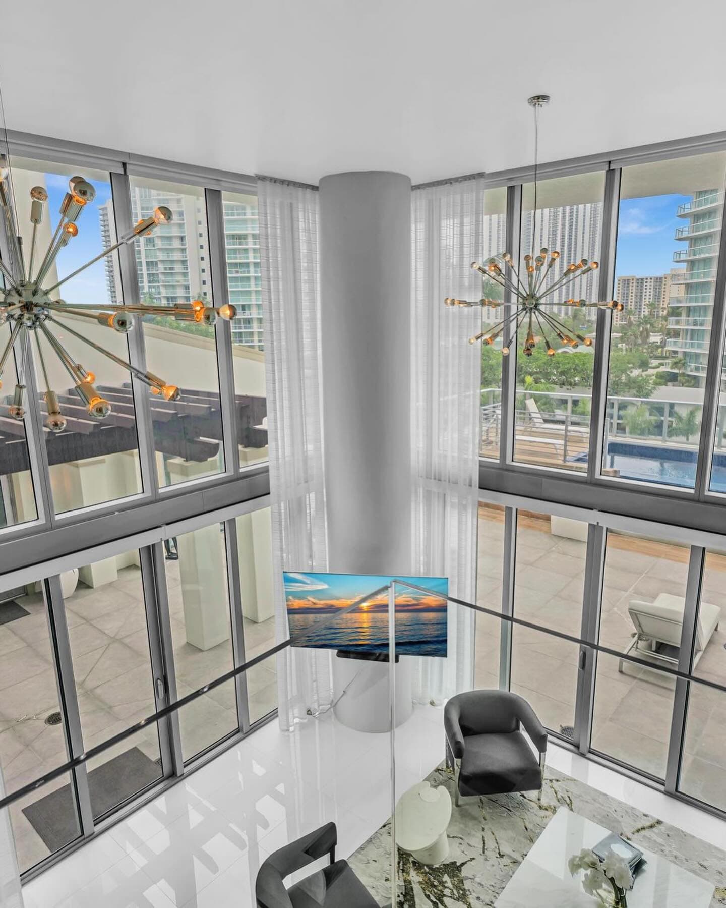 Dining area under a sputnik chandelier in the two-story great room