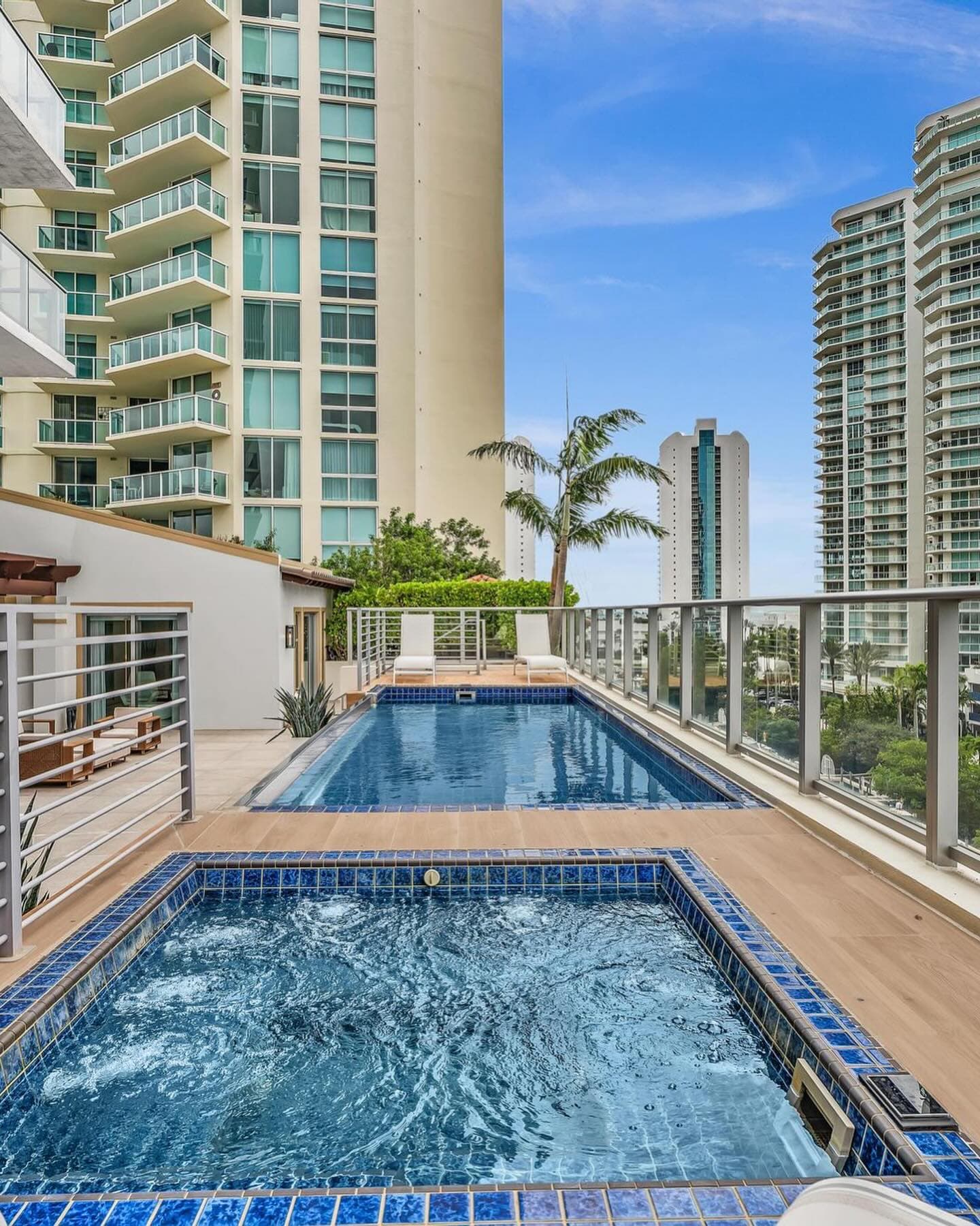 Pool and spa on the terrace of a Parque Towers residence in Sunny Isles Beach, framed by neighboring towers