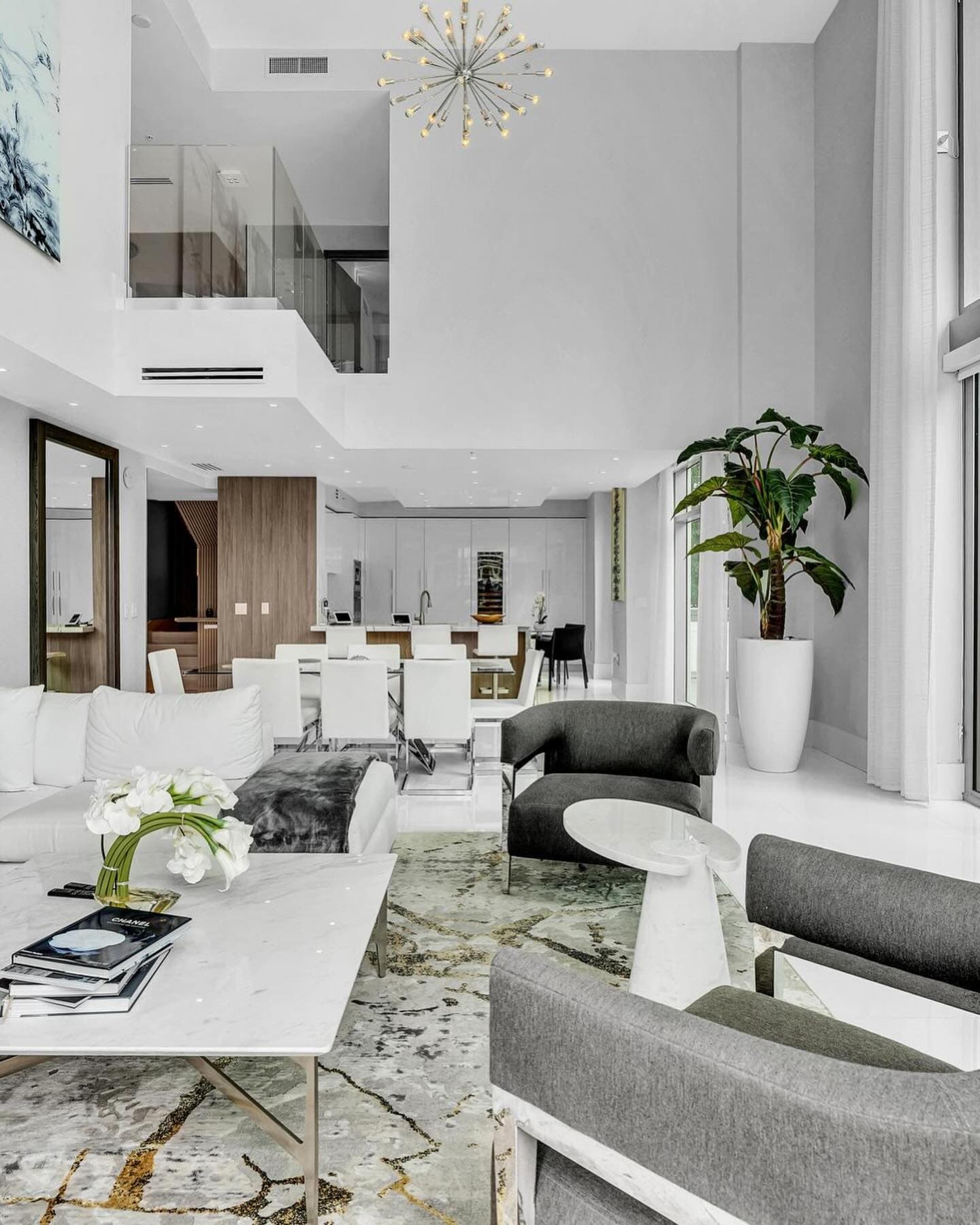Living room with marble coffee table and a view up to the second level