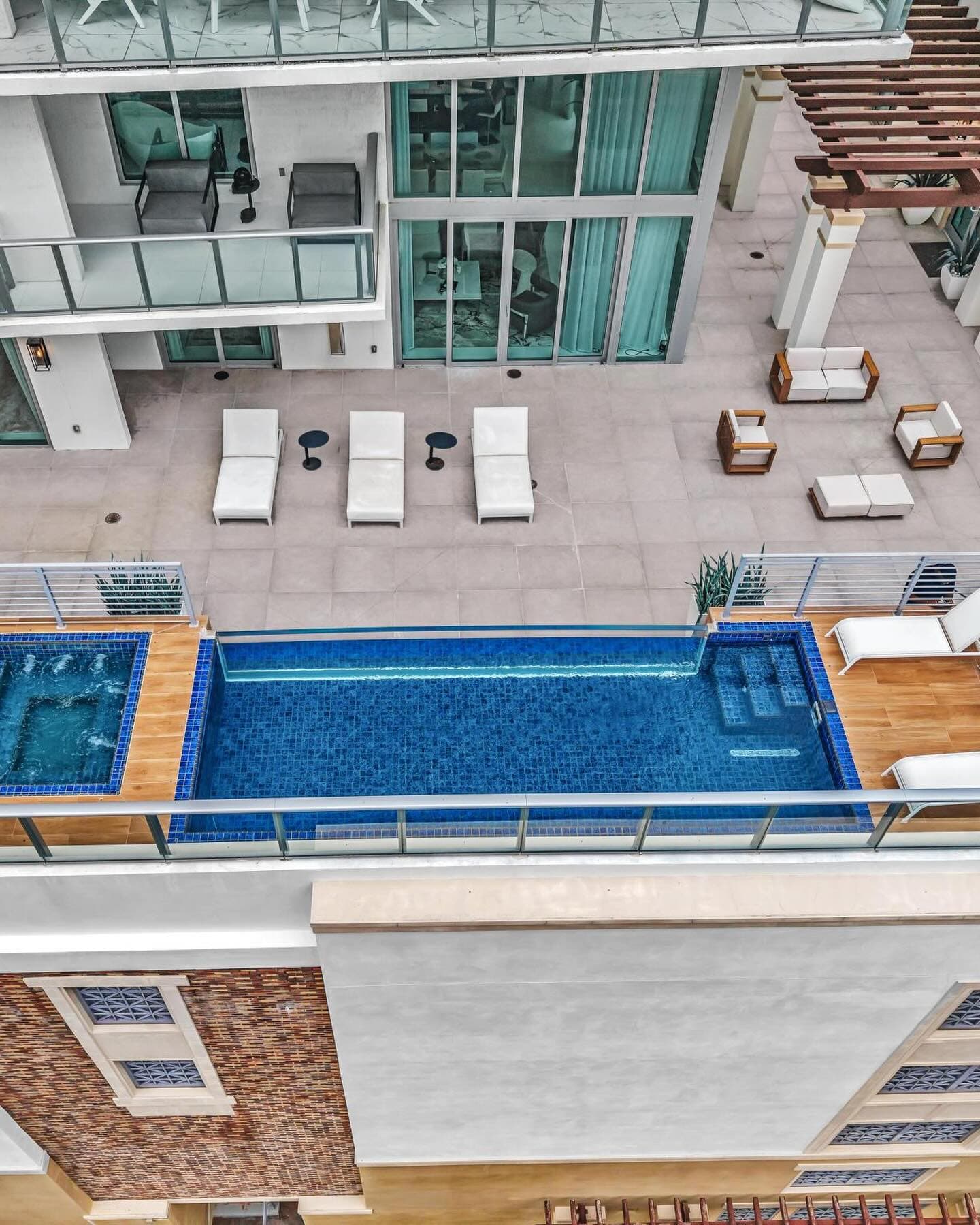 Aerial view of the terrace, lap pool and loungers at a Parque Towers residence in Sunny Isles Beach