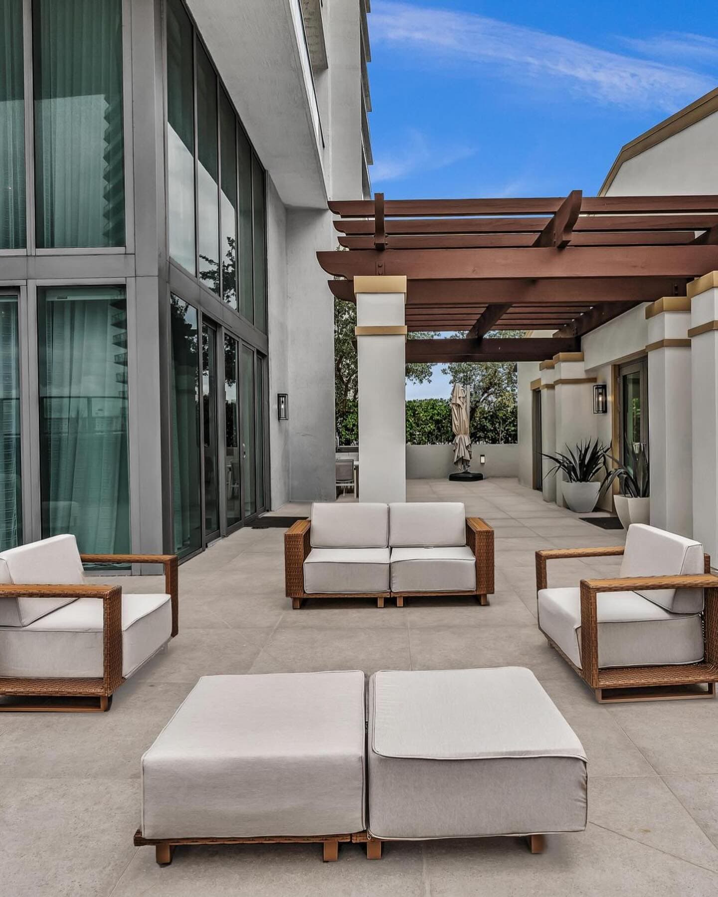 Covered outdoor lounge under a pergola on the terrace