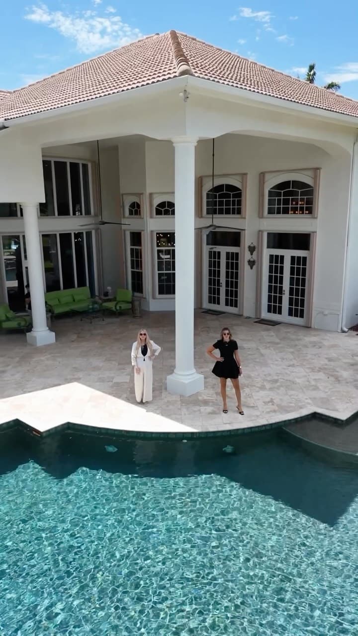 The pool and two-story columned loggia of the Pine Lake Drive estate in Weston
